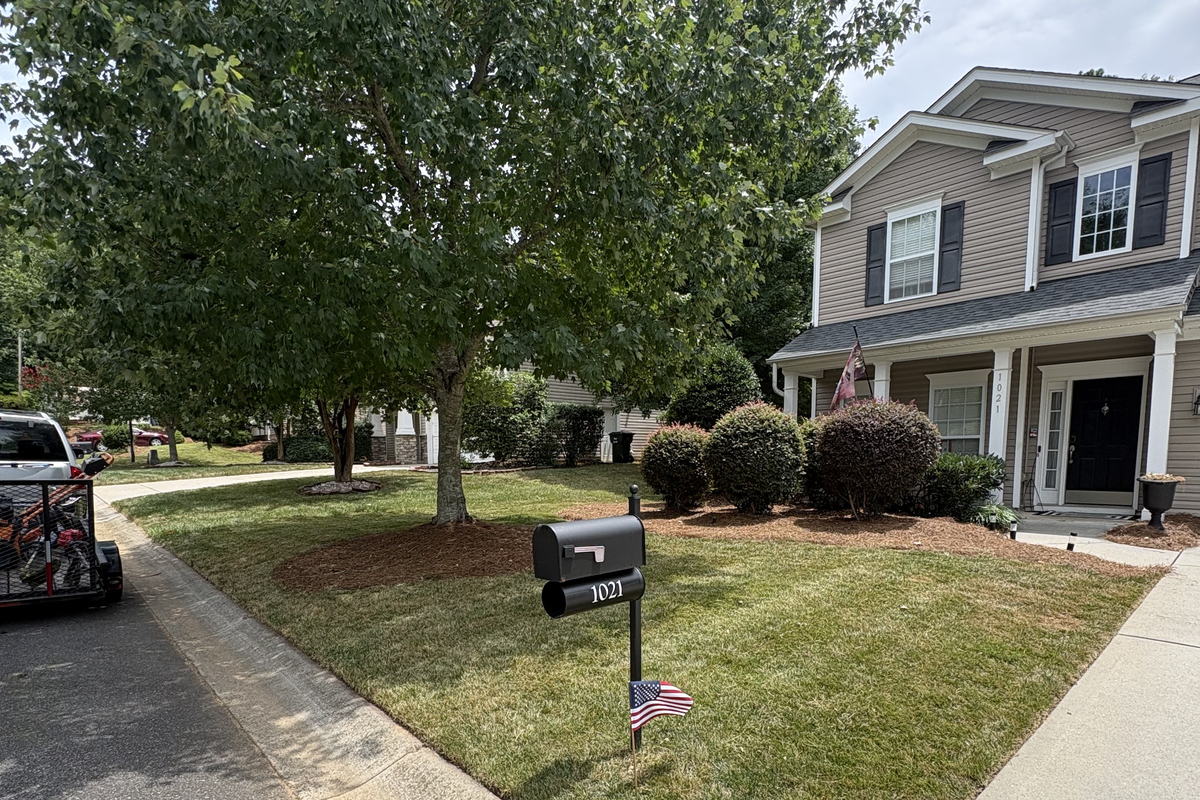 Front yard after weekly lawn maintenance — mowed, edged, and beds re-strawed
